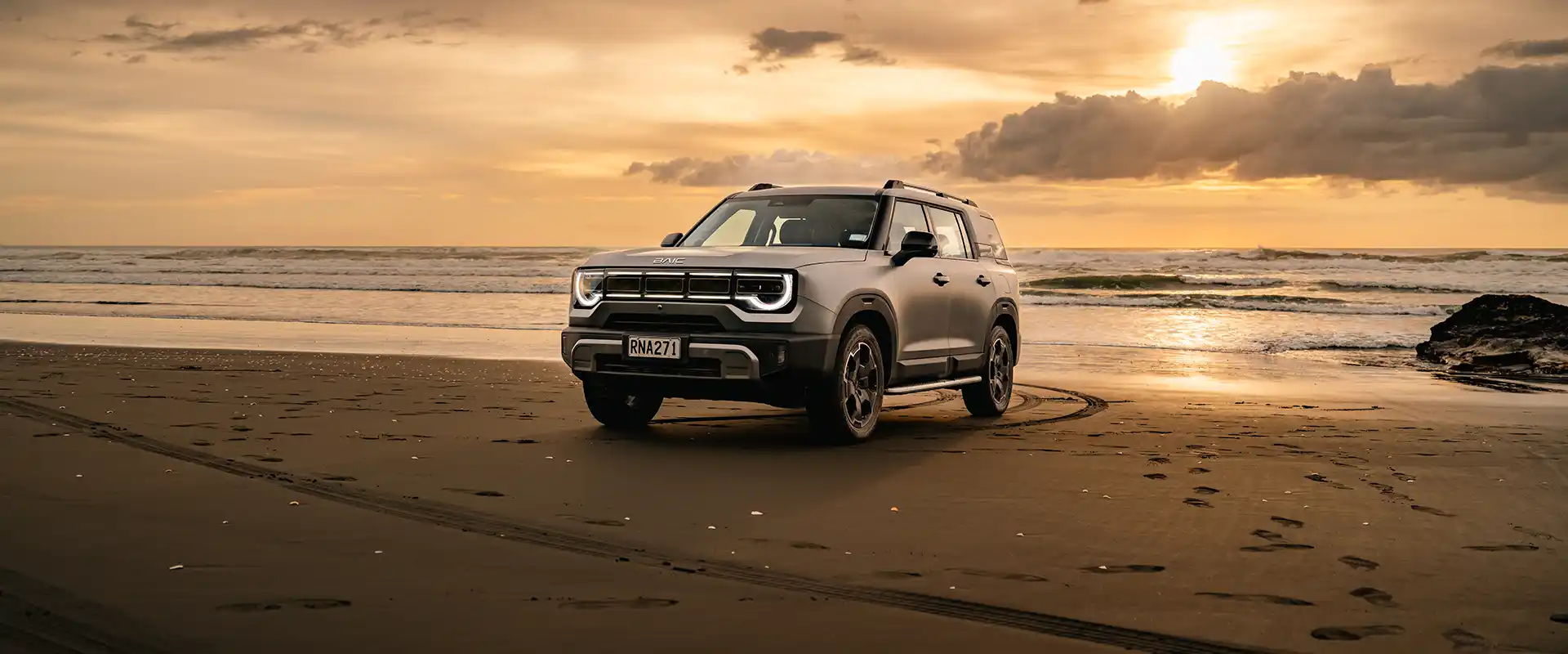 BAIC B30 on a New Zealand beach at sunset